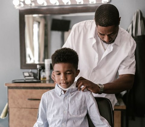 Boy sitting in a barber chair for haircut inspiration